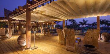 	Terrace of the Samuel Baker bar in the hotel Lopesan Baobab Resort at night	