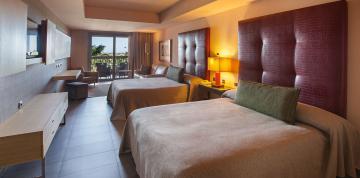 	Interior of the Double Family rooms at the hotel Lopesan Baobab Resort with the terrace in the background	