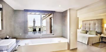 Baignoire avec fenêtre donnant sur la terrasse des chambres doubles supérieures du Lopesan Baobab Resort