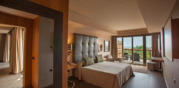 	Interior of the bedroom of the Lopesan Baobab Resort Senior Suites with direct access to the terrace	